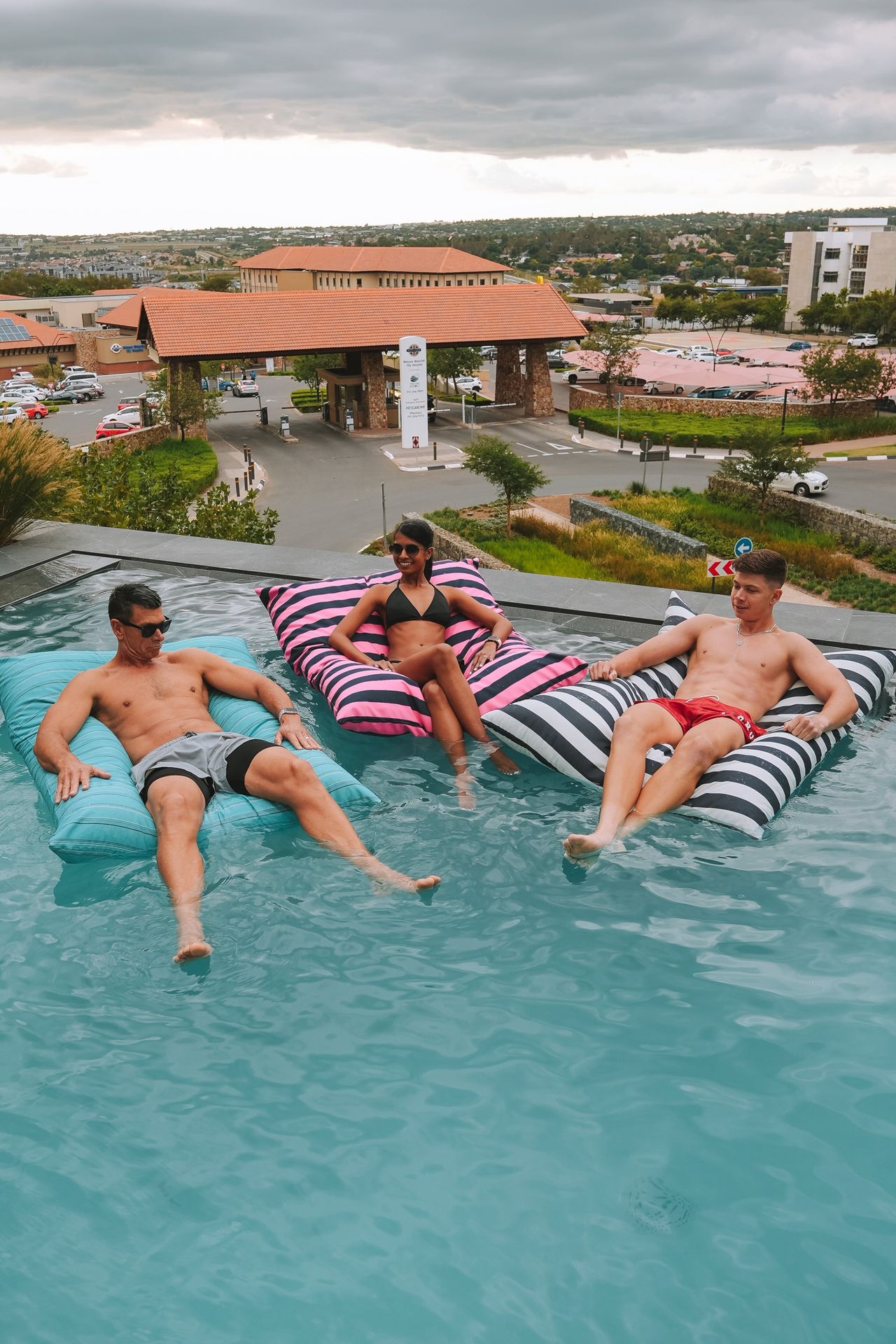 Cushy aqua pool pillow beside the pool