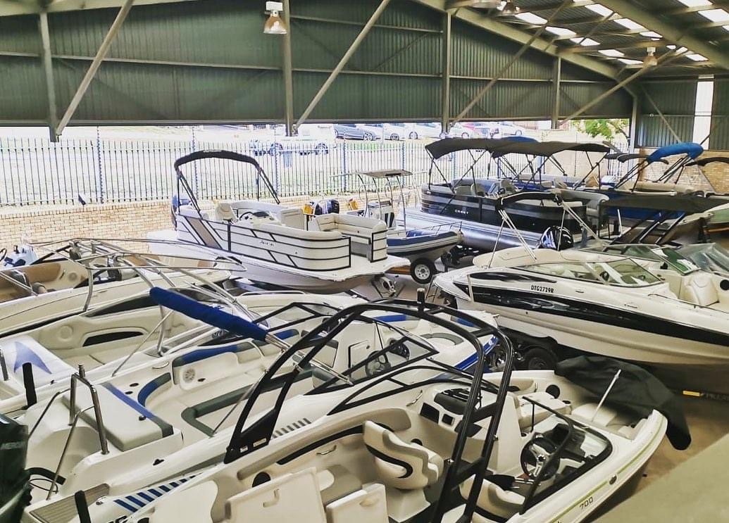 Pontoons and bow riders under cover at Leisure Marine