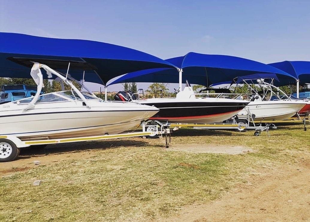 Boats under blue shade sails in the Leisure Marine yard